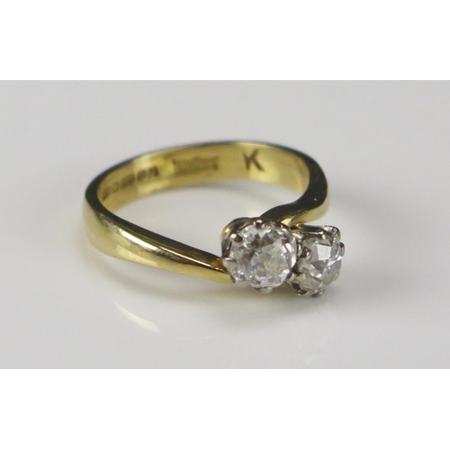 59 - An 18ct Gold and Old Cut Diamond Two Stone Crossover Ring, size H.25, hallmarked c. 4.6-5mm stones, ... 
