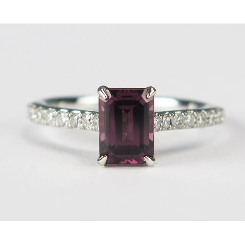 75 - A Platinum Step Cut Rhodalite Garnet and Brilliant Round Cut Diamond Ring, size J.5, 3.63g. 
Sold wi... 