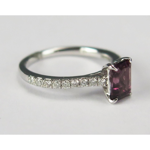 75 - A Platinum Step Cut Rhodalite Garnet and Brilliant Round Cut Diamond Ring, size J.5, 3.63g. 
Sold wi... 