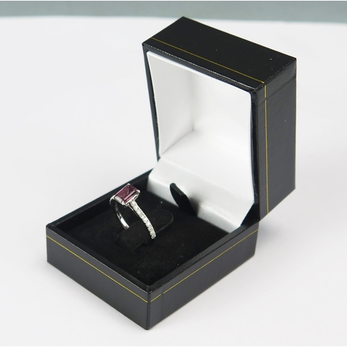 75 - A Platinum Step Cut Rhodalite Garnet and Brilliant Round Cut Diamond Ring, size J.5, 3.63g. 
Sold wi... 