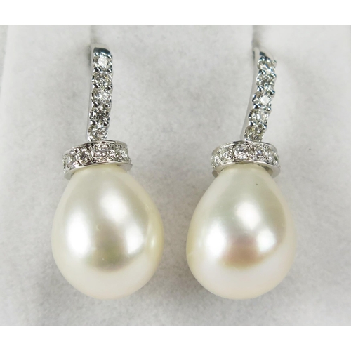 77 - A Pair of High Carat Precious White Metal, Cultured Pearl and Diamond Pendant Earrings with fishhook... 