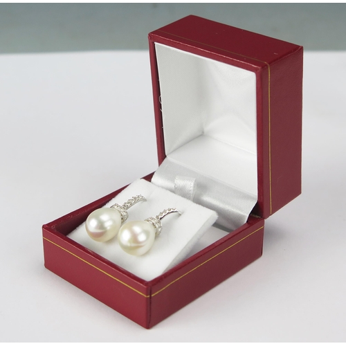 77 - A Pair of High Carat Precious White Metal, Cultured Pearl and Diamond Pendant Earrings with fishhook... 