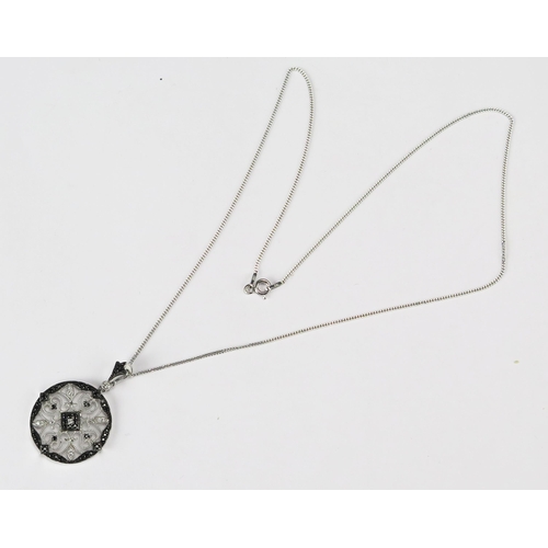 81 - A Round Silver Pendant set with black and white cubic zirconia on a silver chain