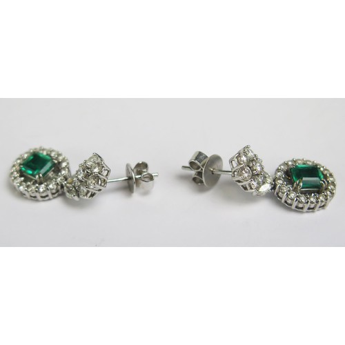 1 - A Pair of 18K White Gold, Emerald and Diamond Pendant Earrings with a top cluster above a suspended ... 