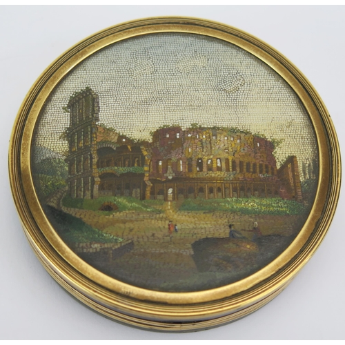 A Fine Grand Tour Micromosaic Tortoiseshell Box decorated with a scene of The Colosseum with figures to the foreground and banded in gold, early 19th century Italian, 8cm diam. x 1.8cm deep