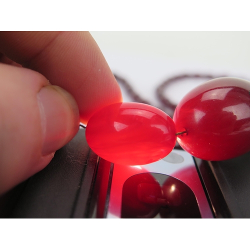 37 - Faux Cherry Amber Bead Necklace, largest bead c. 29.8x21.35mm, 77cm, 50.43g