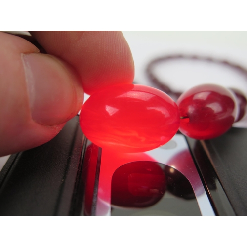 37 - Faux Cherry Amber Bead Necklace, largest bead c. 29.8x21.35mm, 77cm, 50.43g