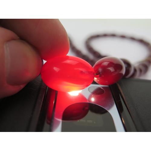 37 - Faux Cherry Amber Bead Necklace, largest bead c. 29.8x21.35mm, 77cm, 50.43g