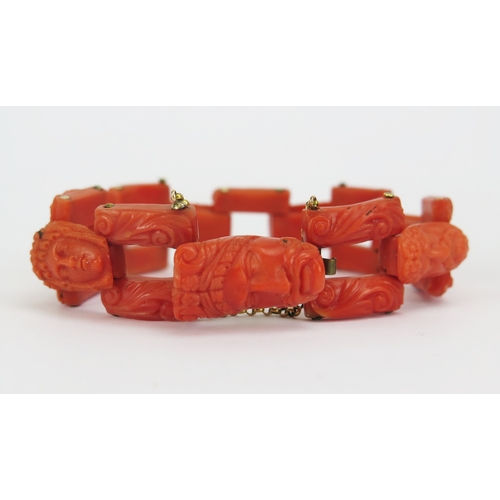21 - 19th century carved coral bracelet with yellow metal mounts decorated with seven male and female hea... 