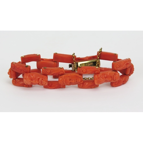 21 - 19th century carved coral bracelet with yellow metal mounts decorated with seven male and female hea... 