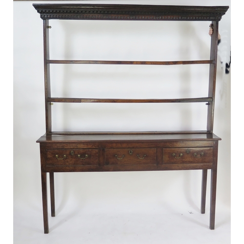An 18th century oak dresser, The upper plate rack with dentil moulded ...