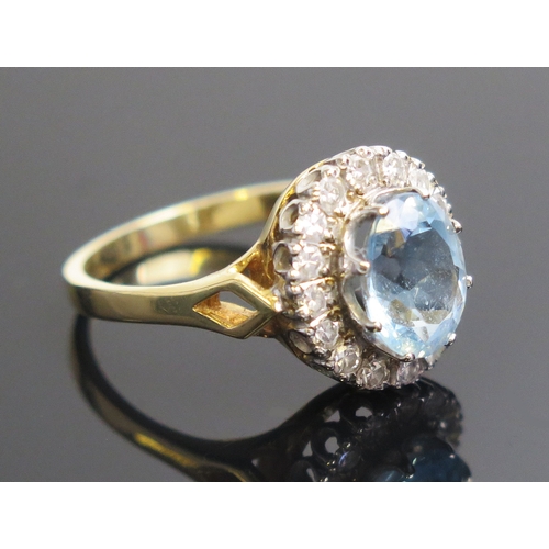 10 - Aqua Marine and diamond cluster ring in an 18ct yellow gold setting, c. 10x8mm principal stone and 1... 