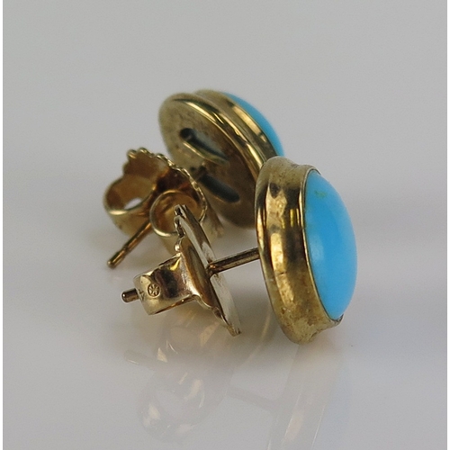 20 - A pair of turquoise stud earrings in 9ct gold settings and with 10K gold butterflies, 12mm diam., 5.... 