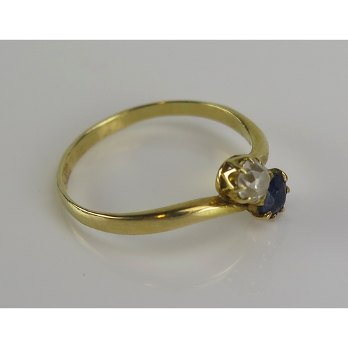 21 - A sapphire and diamond crossover ring in a high carat precious yellow metal setting, size S.5, KEE t... 