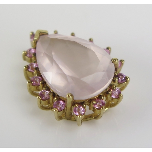 29 - A rose quartz and gem set pear shaped pendant in a 9ct yellow gold setting, 22mm, CCM mark, 4.11g