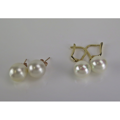 31 - A pair of cultured pearl pendant earrings in 14k yellow gold mounts (c. 30mm drop, 4.41g) and a pair... 