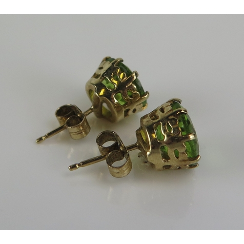 38 - A pair of peridot stud earrings in a 9ct yellow gold mount, 9mm stones, hallmarked, 3.17g