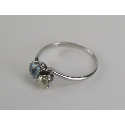 4 - An aqua marine and diamond crossover ring in an 18ct white gold setting, c. 8.8mm aqua and 4.2mm old... 
