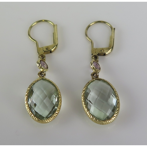 41 - A pair of aqua marine pendant earrings in a 9ct yellow gold mount, c. 41mm drop, 3.86g