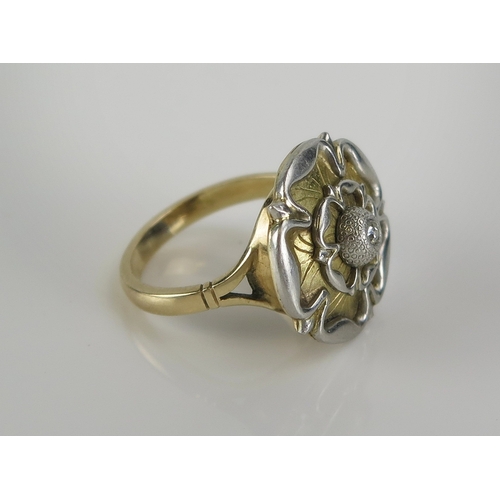 42 - A Tudor rose ring set with an old cut diamond in a precious yellow and white metal setting, 19mm dia... 