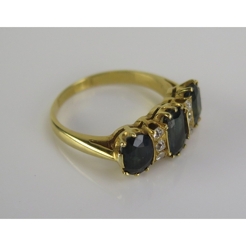 46 - A dark green blue gem and diamond ring in a high carat precious yellow metal setting, c. 9x5mm princ... 