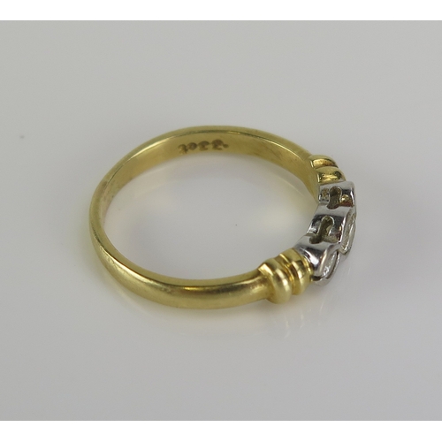 48 - A diamond three stone ring in an 18ct yellow gold setting, c. 3.5mm principal platinum set stone, si... 