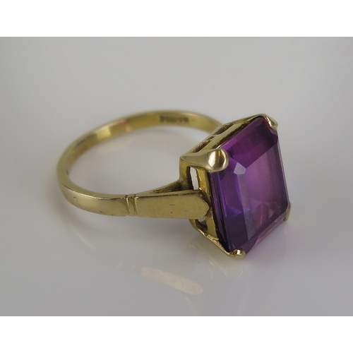 55 - A purple moissanite? ring in a 9ct yellow gold setting, c. 12.1x10mm stone, size M.5, hallmarked, 3.... 