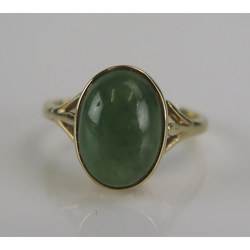 56 - A jade cabochon ring in a 9ct gold setting, 15x11mm head, size S.5, 4.15g