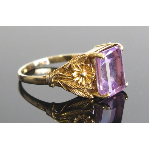8 - An amethyst ring in a 9ct gold setting with foliate decorated shank, c. 18x10mm stone, size S, hallm... 
