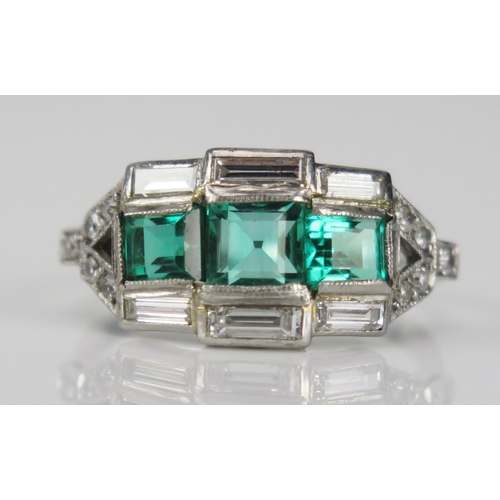 353 - A Deco style emerald and baguette cut diamond in a precious white metal setting, size O, Kee tests a... 