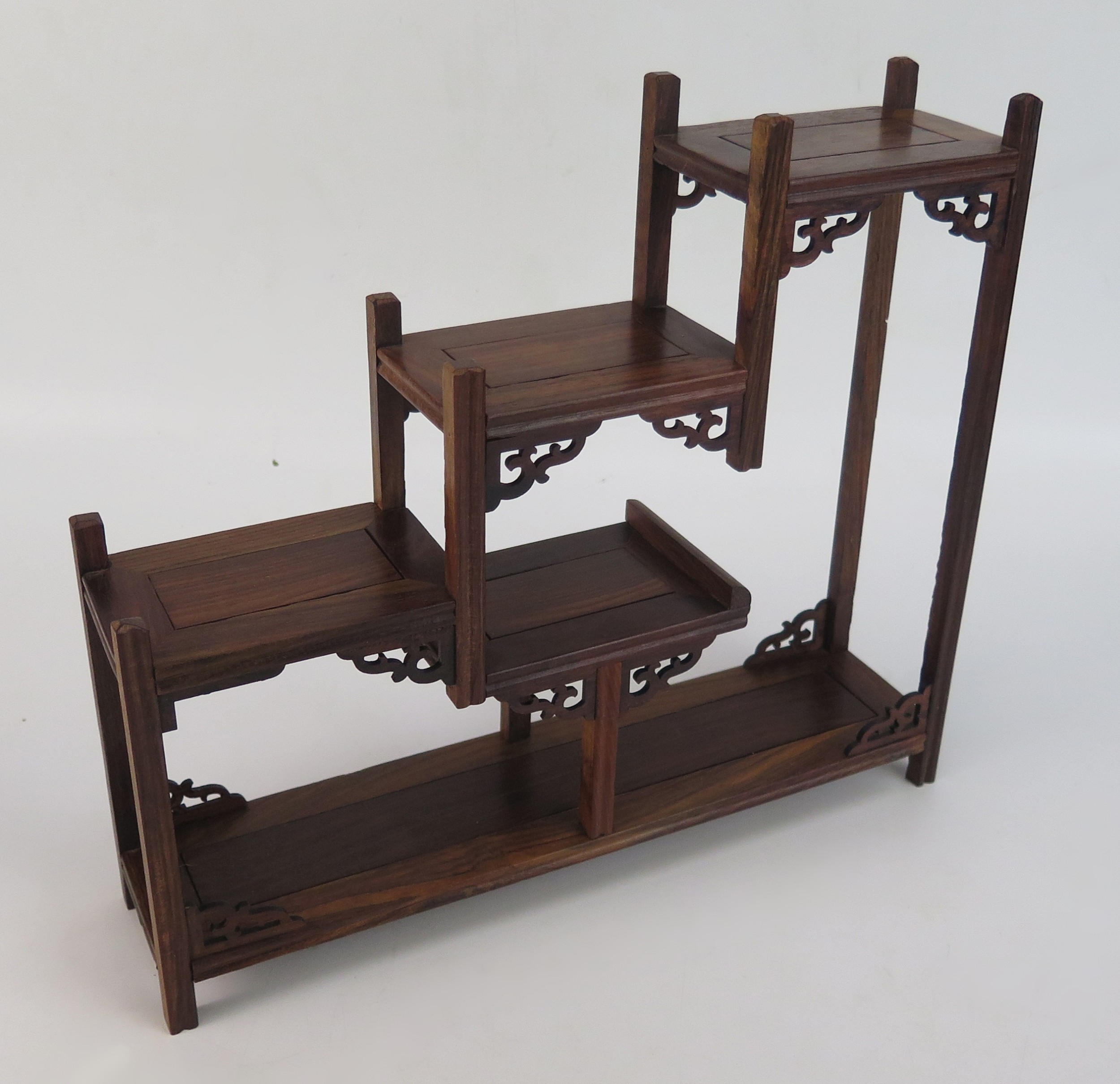 Two Chinese wood stands of asymmetric design, raised on block feet ...