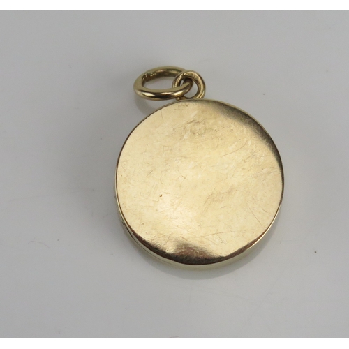 223 - A diamond and green guilloche enamel locket in a high carat precious yellow metal, the c. 2.2mm old ... 