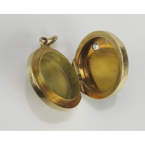 223 - A diamond and green guilloche enamel locket in a high carat precious yellow metal, the c. 2.2mm old ... 