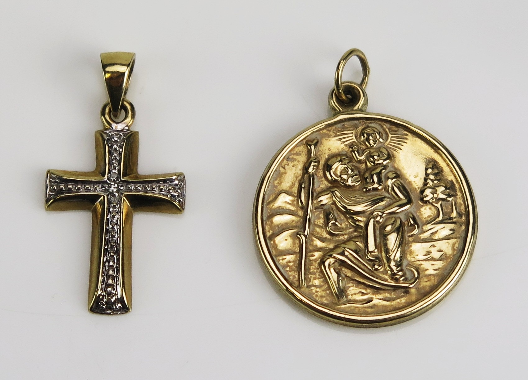 A 9ct yellow gold cross pendant, 22mm drop, loop stamped 9K, and a 9ct ...
