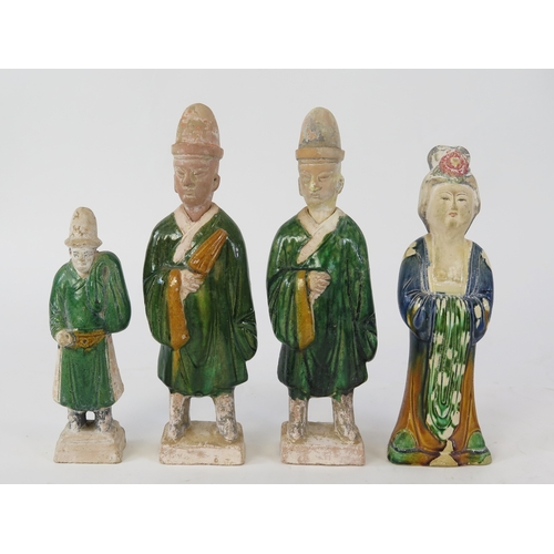 1100 - A group of four 19th century pottery figures, dressed in traditional robes, 19cm, 25cm and 28cm high... 
