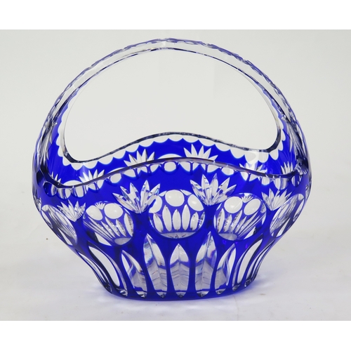 1108 - A clear glass and blue overlay glass basket, of oval form with arched handle, 27cm wide, 24cm high.