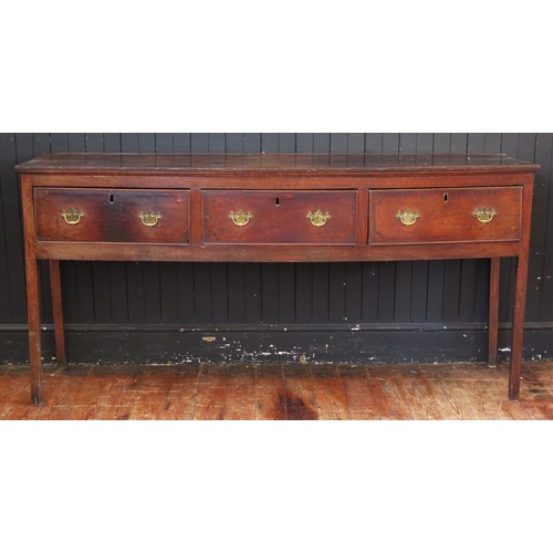 1761 - A late 18th century oak dresser base, the rectangular top with a moulded edge, above three short fri...