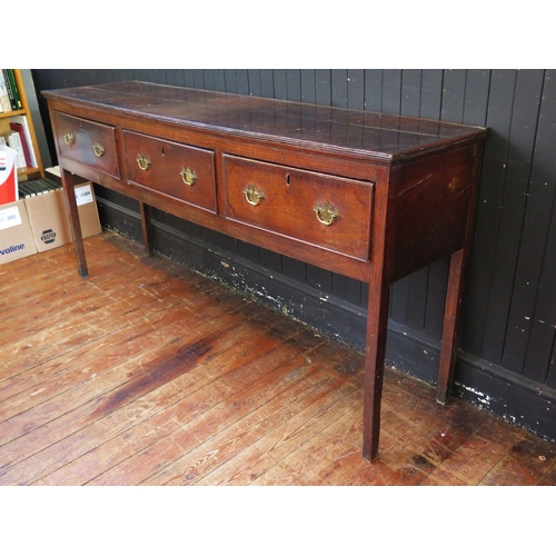 1761 - A late 18th century oak dresser base, the rectangular top with a moulded edge, above three short fri... 