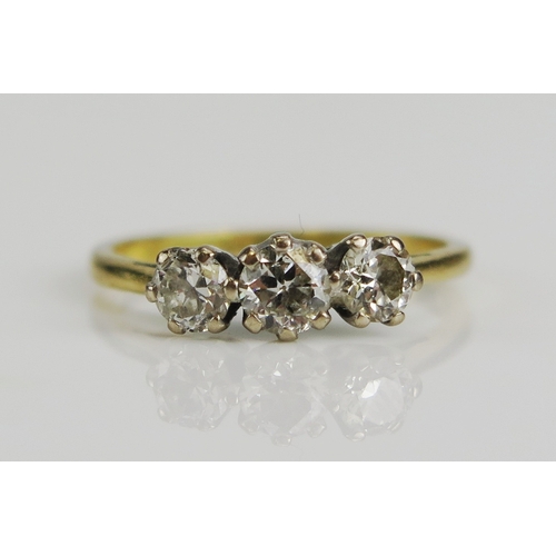 145 - An 18ct yellow gold and diamond three stone ring in a platinum setting, size I.5, stamped 18ct & PLA... 