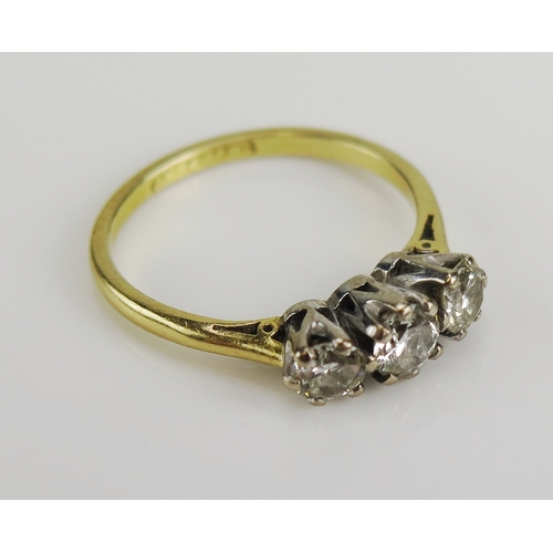 145 - An 18ct yellow gold and diamond three stone ring in a platinum setting, size I.5, stamped 18ct & PLA... 