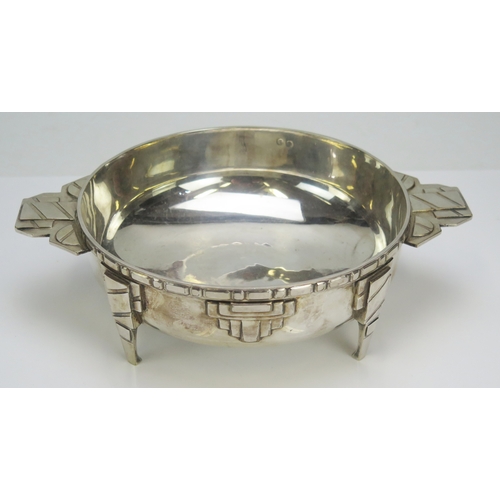 555 - A continental Art Deco style silver plated centrepiece bowl with twin handles and applied geometric ... 