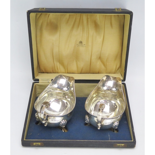 563 - A pair of George VI silver sauce boats, maker Harrison Brothers & Howson, Sheffield 1945, each with ... 