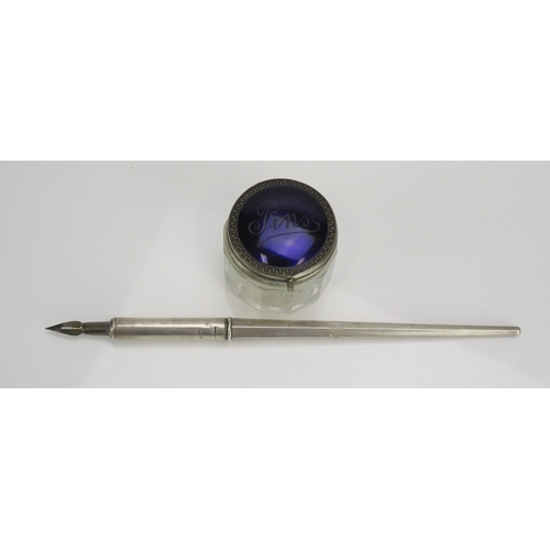 565 - A silver dip pen, marks rubbed and worn, 22cm long, together with a clear glass and mounted pin jar