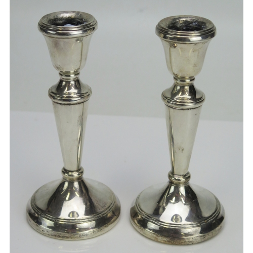 593 - A Pair of Elizabeth II silver candlesticks, maker's marks worn, Birmingham, 1990, with urn sconces o... 