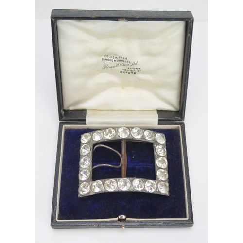 598 - A white metal and paste set buckle of rectangular outline, cased.