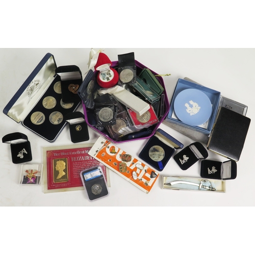664 - A collection of coins including commemorative crowns and a silver Tower of London portcullis pendant... 