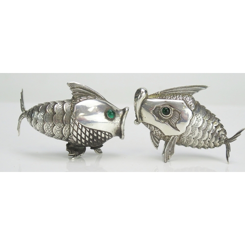 586 - A pair of Spanish silver condiments in the form of articulated fish, with inset green glass eyes, st... 