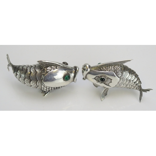 586 - A pair of Spanish silver condiments in the form of articulated fish, with inset green glass eyes, st... 