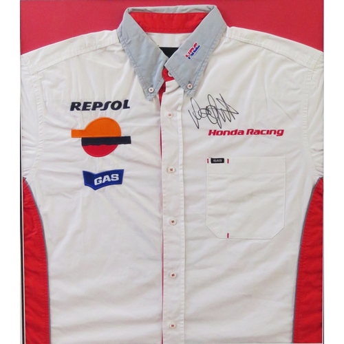 11 - Valentino Rossi; signed Honda Racing team shirt, with two photographs, mounted and framed, with COA,... 