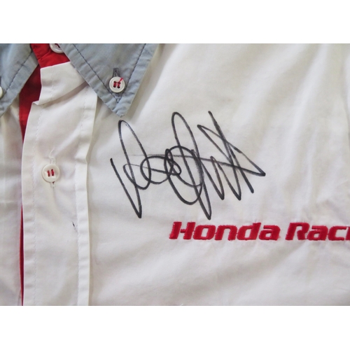 11 - Valentino Rossi; signed Honda Racing team shirt, with two photographs, mounted and framed, with COA,... 